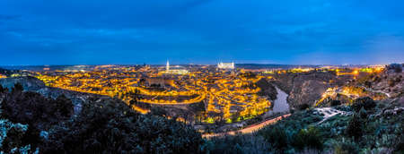 Toledo and Tajo river panorama night in Castilla La Mancha province, Spainの写真素材
