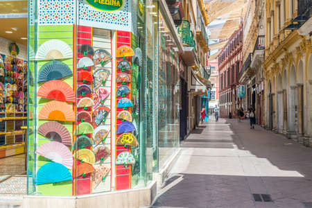 SEVILLE, ES - JULY 26, 2017: Calle Sierpes is a traditional and busy shopping street in the Spanish...