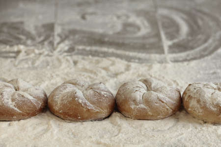 Bread and flour on wooden tableの写真素材