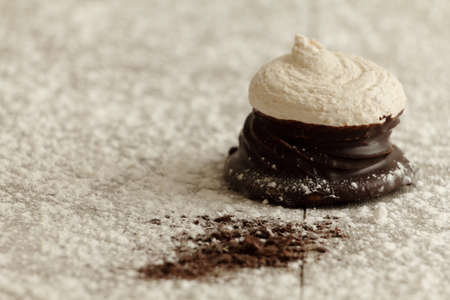 chocolate and coconut meringue on wooden tableの写真素材