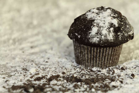 chocolate cupcake with icing sugar,chocolate cupcake with icing sugar on wooden tableの写真素材