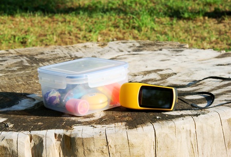 geocaching concept with geocache and GPS in nature