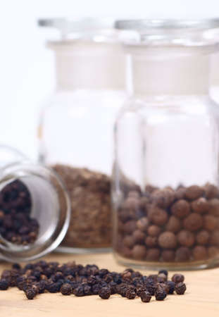 black pepper in glass jar with other spices in backgroundの写真素材