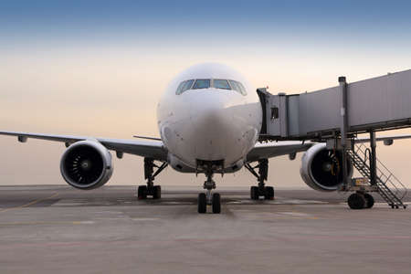 Civil passenger airplane standing near the gate.