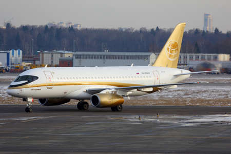 Sheremetyevo, Moscow Region, Russia - 23 March, 2014: Tsentr-Yug Sukhoi Superjet 100 RA-89004 in golden livery taxiing at Sheremetyevo international airport.のeditorial素材