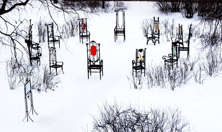 12 chairs are set in the snow under the open sky の写真素材