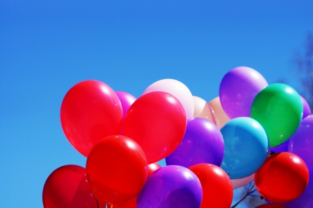Many-colored balloons on the background of blue sky の写真素材