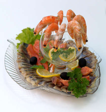  Boiled shrimps with lemon and parsley on a platter with an assortment of fish dishes.                         の写真素材