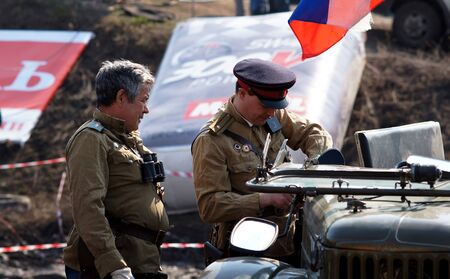 20-21 April 2013 ,city of Magnitogorsk,Russia, On a specially prepared track competitions conducted off-road-sprint  First dirt 2013   Demonstration performances of the club  Antique cars and motorcycles,the driver examines the car before the race のeditorial素材