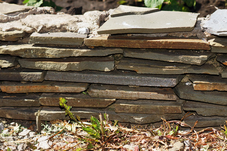 The remains of the man-made walls of stone rocks.