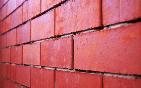 Rude is not plastered wall built of red bricks.の写真素材