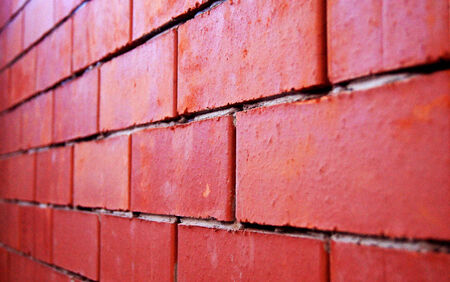 Rude is not plastered wall built of red bricks.の写真素材