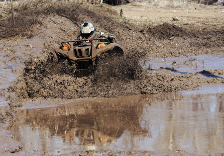 Extreme driving ATV on overcoming obstacles dirt.の写真素材
