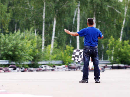 Sporting judge with the flag at the finish.の写真素材