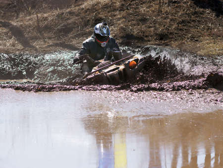 Extreme driving ATV on overcoming mud obstacles.の写真素材