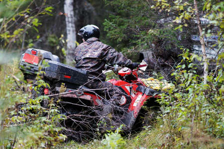 Extreme driving ATV on overcoming terrain.