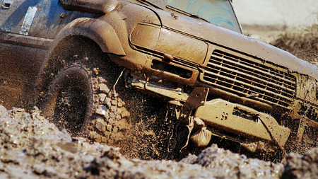 SUV overcomes obstacles dirt.の写真素材