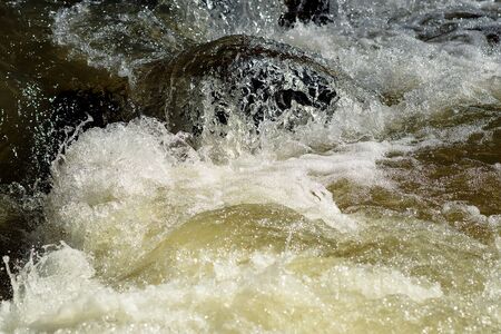 The rapid flow of water during floods in the mountains.の写真素材