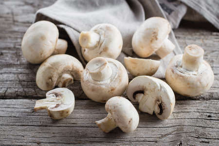 Fresh mushrooms champignons on a wooden background. Autumn Harvest Food Vegetarian Vegetableの写真素材