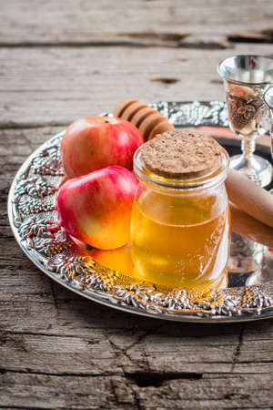 Honey Jar and Apples on beautiful tray on wooden table background. Jewish Holiday Rosh Hashanah Conceptの写真素材