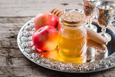 Honey Jar and Apples on beautiful tray on wooden table background. Jewish Holiday Rosh Hashanah Conceptの写真素材