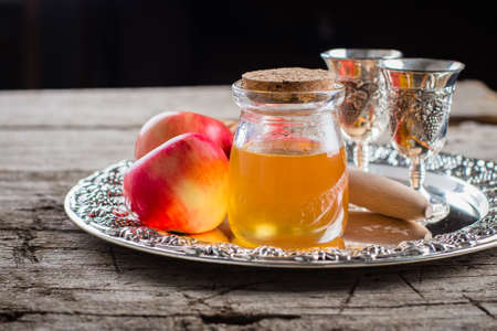 Honey Jar and Apples on beautiful tray on wooden table background. Jewish Holiday Rosh Hashanah Conceptの写真素材