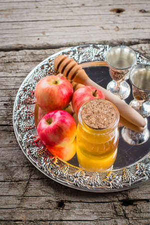 Honey Jar and Apples on beautiful tray on wooden table background. Jewish Holiday Rosh Hashanah Conceptの写真素材