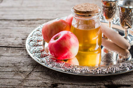 Honey Jar and Apples on beautiful tray on wooden table background. Jewish Holiday Rosh Hashanah Conceptの写真素材