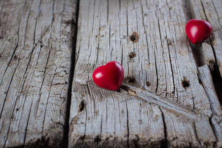 Valentine Day Card Love Concept. Creative Idea. Ceramic Red Heart on old wooden background. Copy Spaceの写真素材