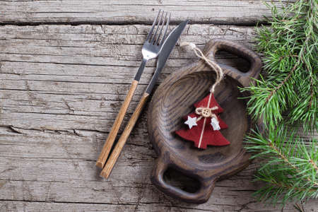 Christmas table setting with plate, silverware and decorations over gray stone table. Top view copy space.の写真素材