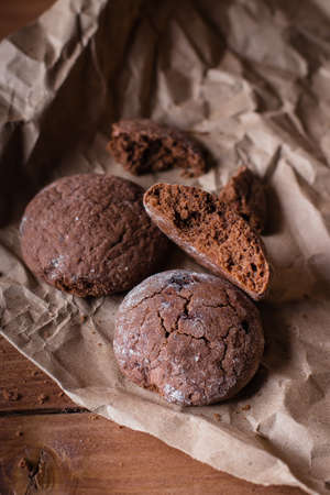 Chocolate Cookies on Paper on Wooden Table Background. Sweet Snack. Copy spaceの写真素材