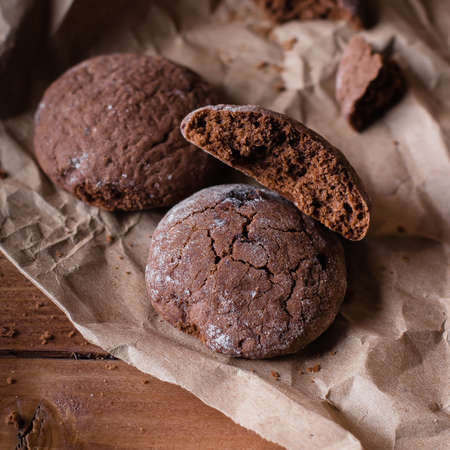 Chocolate Cookies on Paper on Wooden Table Background. Sweet Snack. Copy spaceの写真素材