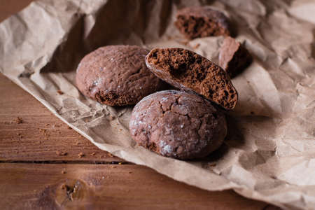 Chocolate Cookies on Paper on Wooden Table Background. Sweet Snack. Copy spaceの写真素材