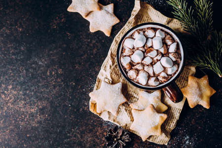 Top view of Hot Christmas Drink. Holiday beverage Cacao or Chocolate with marshmallow and Cookies Shape Star. Stone Background, Copy spaceの写真素材