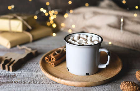 Christmas cocoa with marshmallow on wooden table background. Holiday drink with festive decorationの写真素材