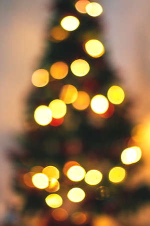 Abstract blurred background of blue and silver glittering shine bulbs lights garland. Christmas wallpaper decorations concept. Xmas holiday backgroundの写真素材