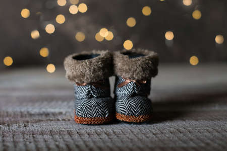 Holiday Christmas Baby Toy Small Boots on Wooden Table Background. Cozy Concept.