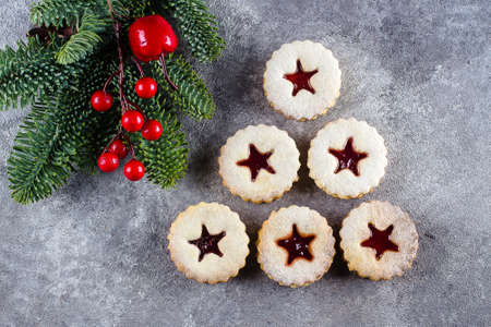 New Year 2020 Tree. Christmas Linzer cookies with jam and fir tree branch on gray concrete table background. Top view, flat layの写真素材