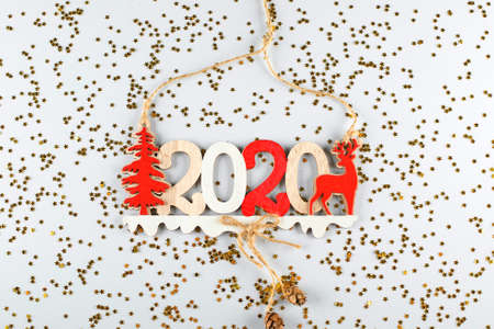Christmas decor 2020 with little star confetti glitter on gray background. Flat lay, top view.