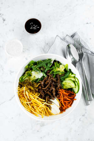 Healthy lunch bowl on marble table background. Delicious balanced food concept. Top view, flat lay, copy spaceの写真素材