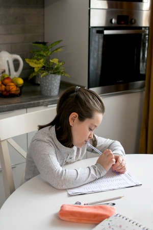 Pretty cute schoolgirl 7-8 years old studying at home. Home school, online education, home...