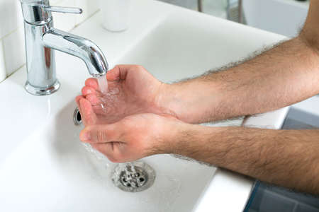Man washing hands with soap and lathering suds. Protect against the coronavirus. Coronavirus...