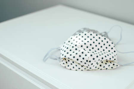 Handmade medical mask. Face mask protection against pollution, virus, flu and coronavirus. Health care and surgical concept. DIYの写真素材