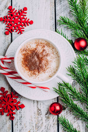 Christmas breakfast. Cup of coffee, candy sticks and holiday decoration toys, tree fir branches on white wooden table. Top view, copy space. Morning New Year 2018. Winter conceptの写真素材