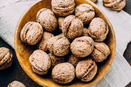 Whole walnuts on dark stone concrete table background. Copy space. Healhty Vegetarian Vegan Food Conceptの写真素材