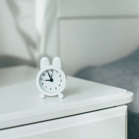 Alarm clock near the bed at homeの写真素材