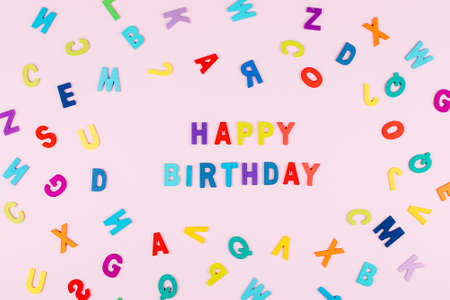Happy Birhday Card. Bright multicolored alphabet background with word Happy Birthday. Flat lay, top...