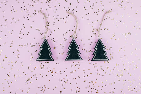 Christmas background with three decoration christmas black tree. Golden sparkles stars on pink...