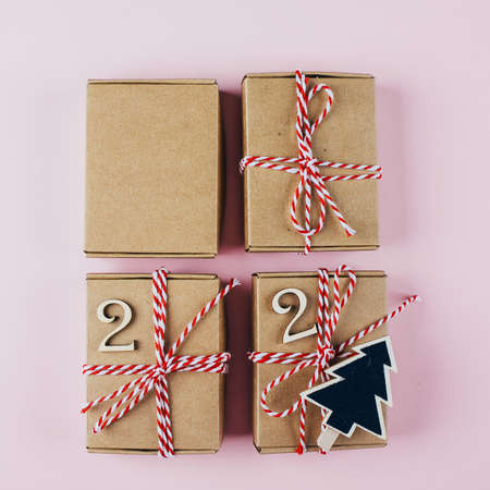 Preparation of advent calendar. Advent christmas calendar. Wrapped gifts on red background. Top...