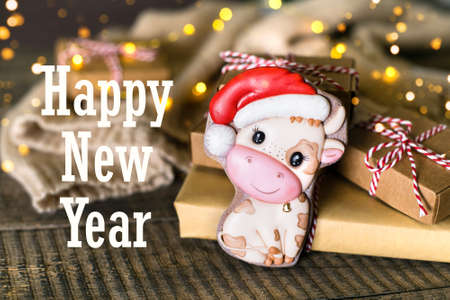 Happy New Year with wrapped gifts on wooden tableの写真素材